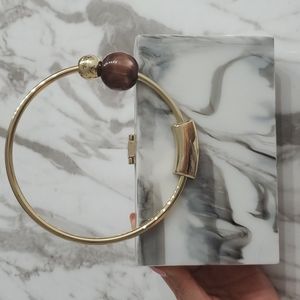 Marble clutch with bead and gold handle
